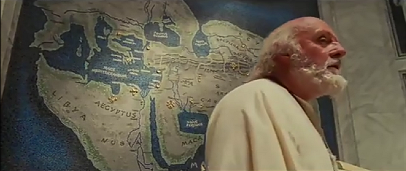 Ptolomeo el viejo con las conquistas de Alejandro Magno plasmadas en un gran mapa